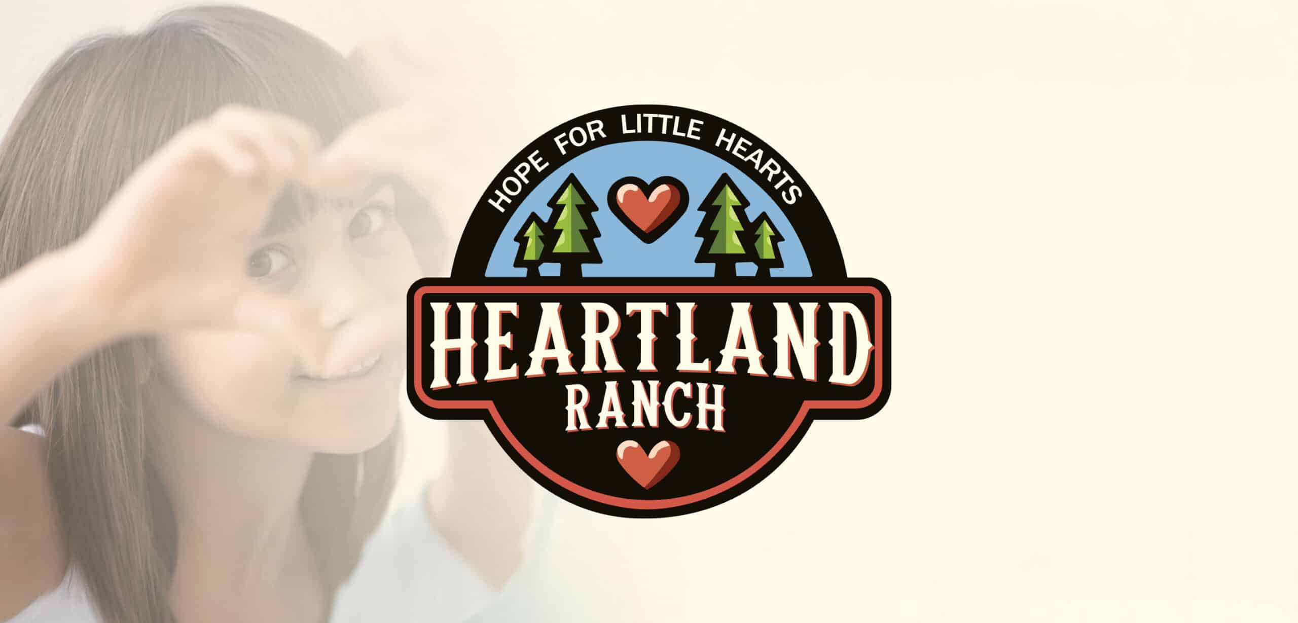 Heartland Ranch logo with a child in the background making a heart with their hands