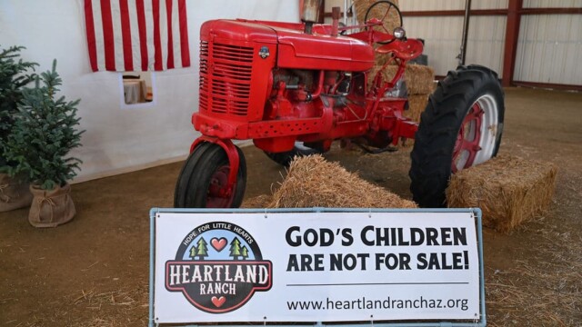 Photo booth with "God's children are not for sale" sign