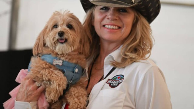 AucHope For Little Hearts Fundraiser worker holding small dog