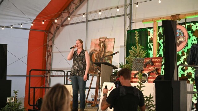 Woman speaking on Hope For Little Hearts Fundraiser stage