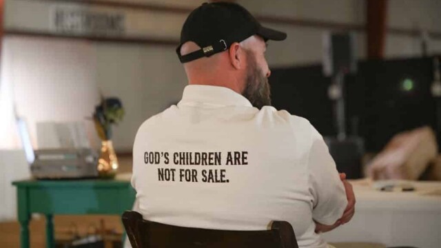 Man wearing Heartland Ranch shirt that reads "God's children are not for sale"